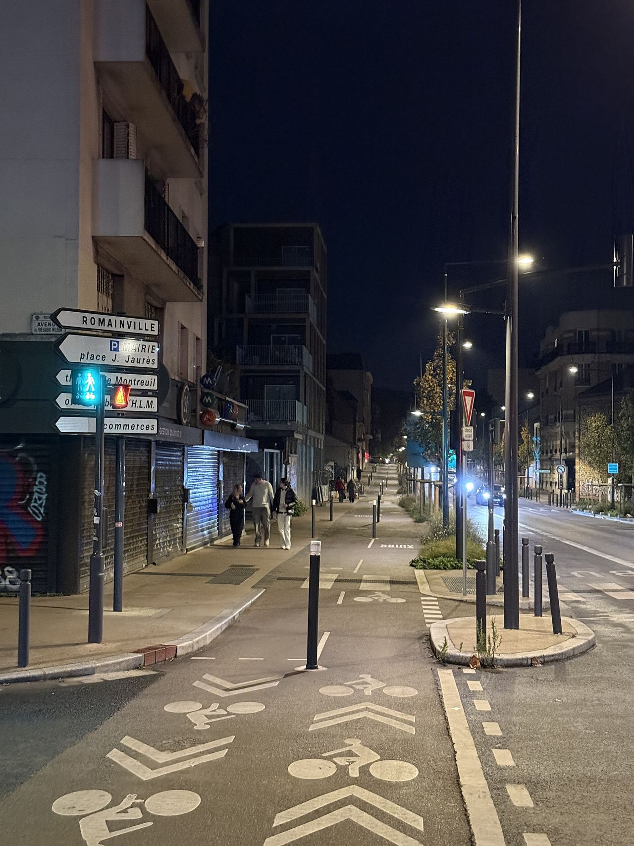 Voie cyclable de l'avenue Gabriel-Péri à Montreuil, de nuit, éclairée par les lampadaires
